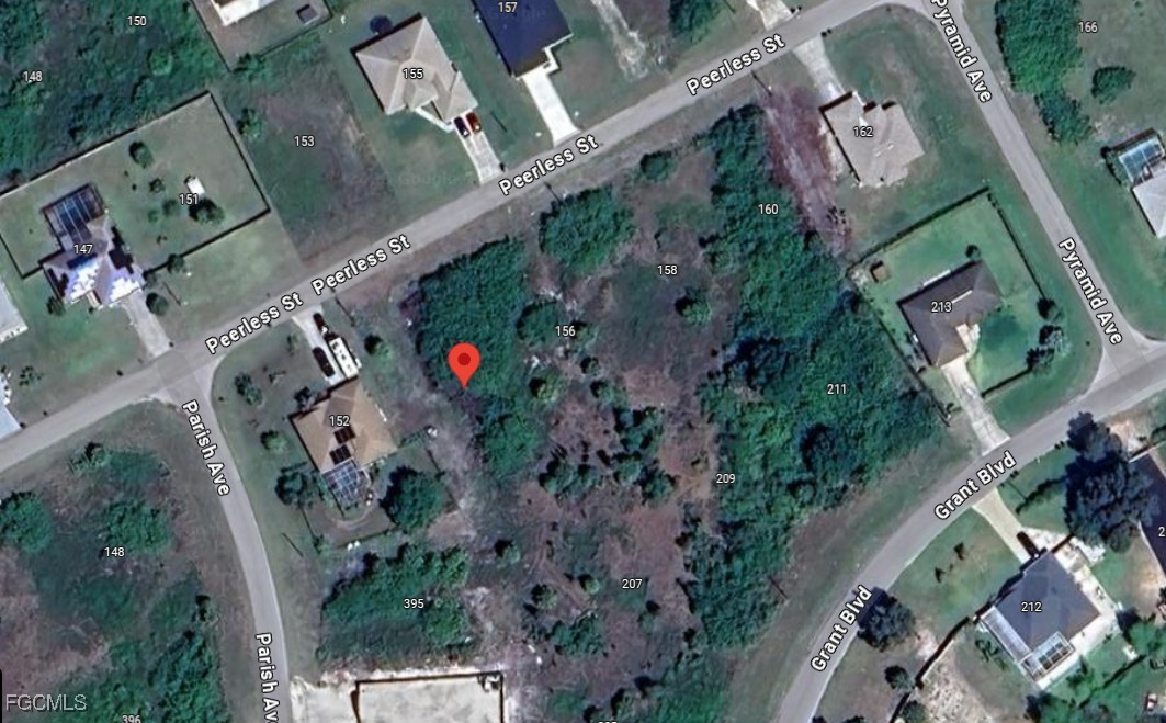 154 Peerless Street Lehigh Acres, FL 33974 - Photo 4 of 4 an aerial view of a house with outdoor space