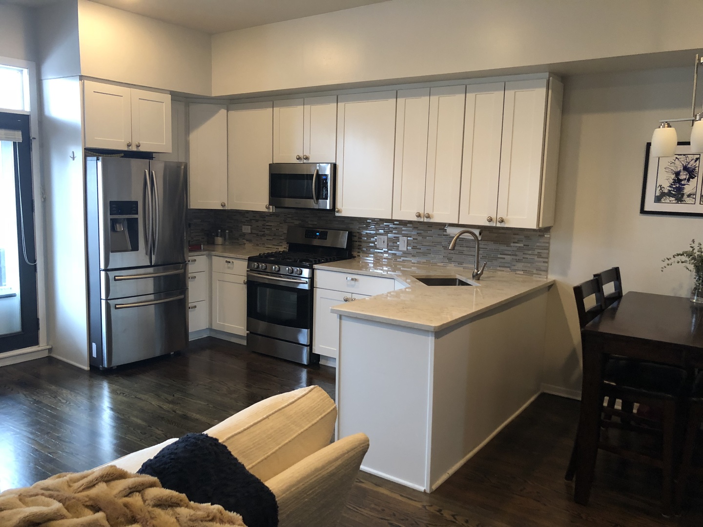 1335 North Mohawk Street, Unit 2N Chicago, IL 60610 - Photo 6 of 15 a kitchen with a refrigerator stove and wooden floor
