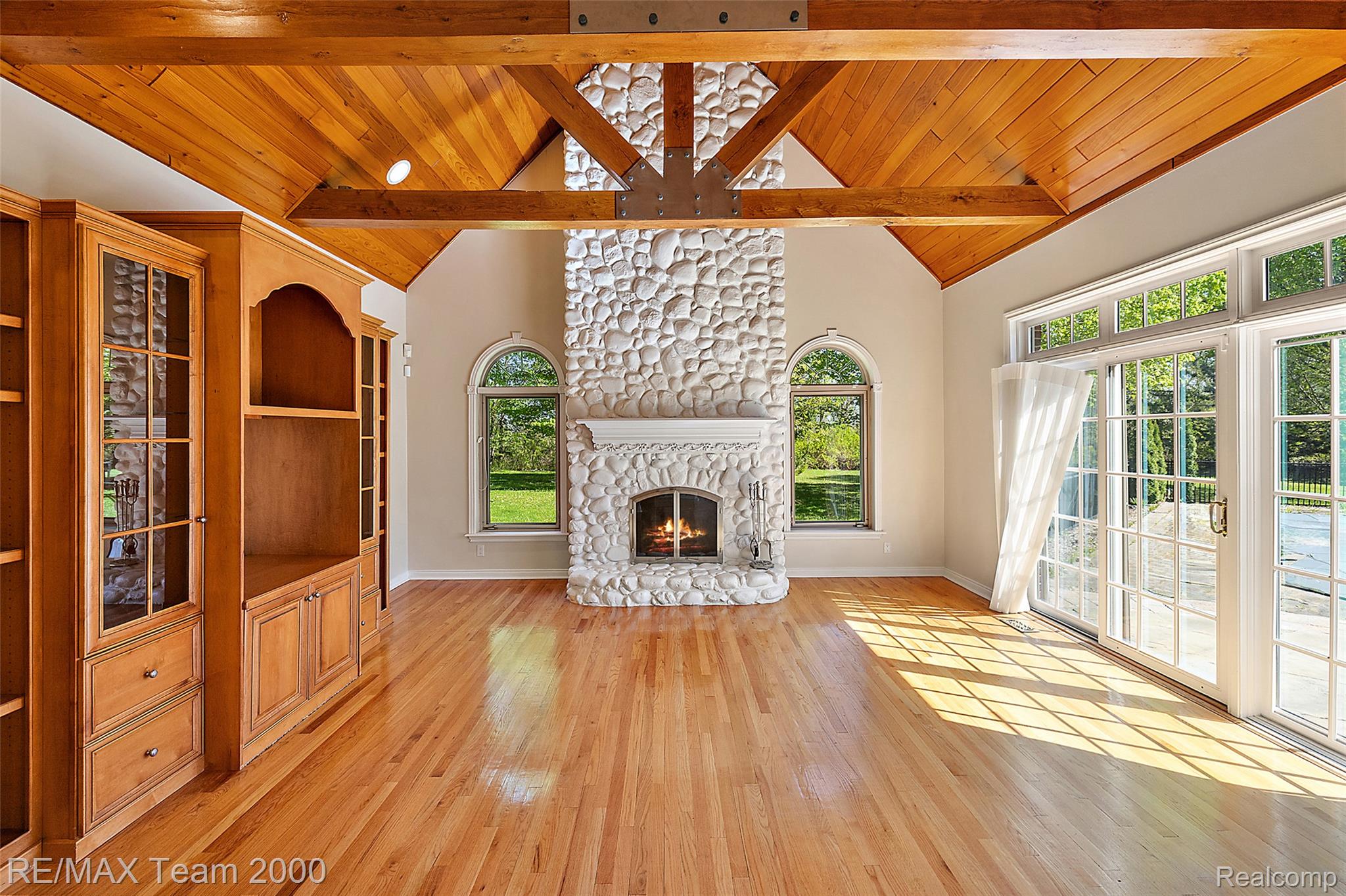 630 Sheldon Court Rochester, MI 48306 - Photo 36 of 94 Unfurnished living room featuring light wood-style floors and a stone fireplace