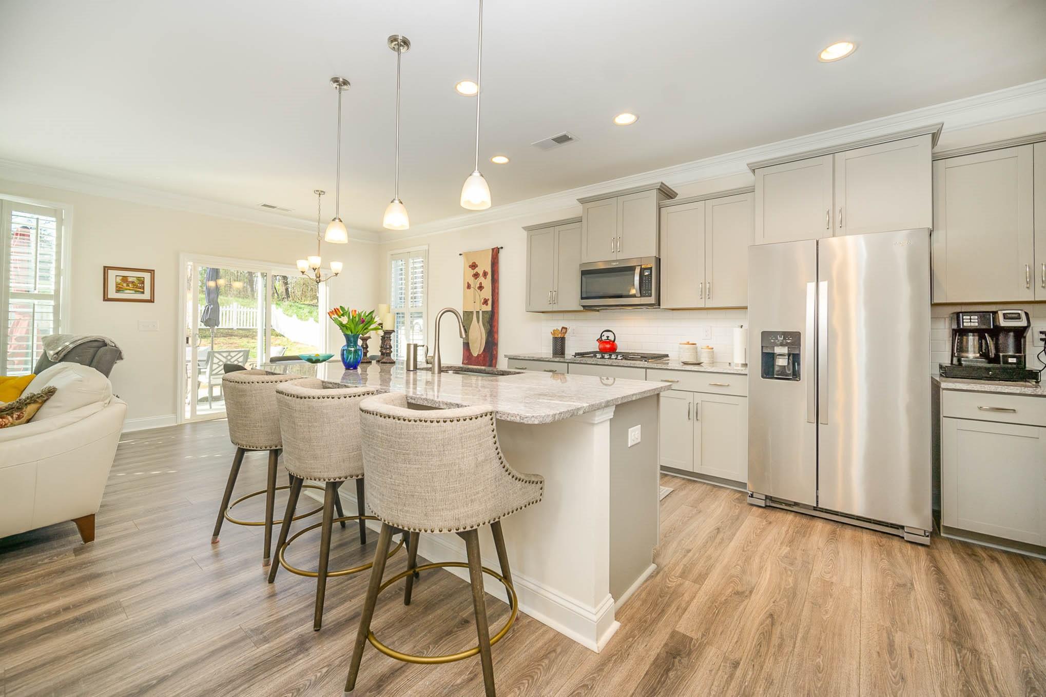 6029 Redwood Pine Road Concord, NC 28027 - Photo 11 of 48 a kitchen with kitchen island white cabinets and stainless steel appliances