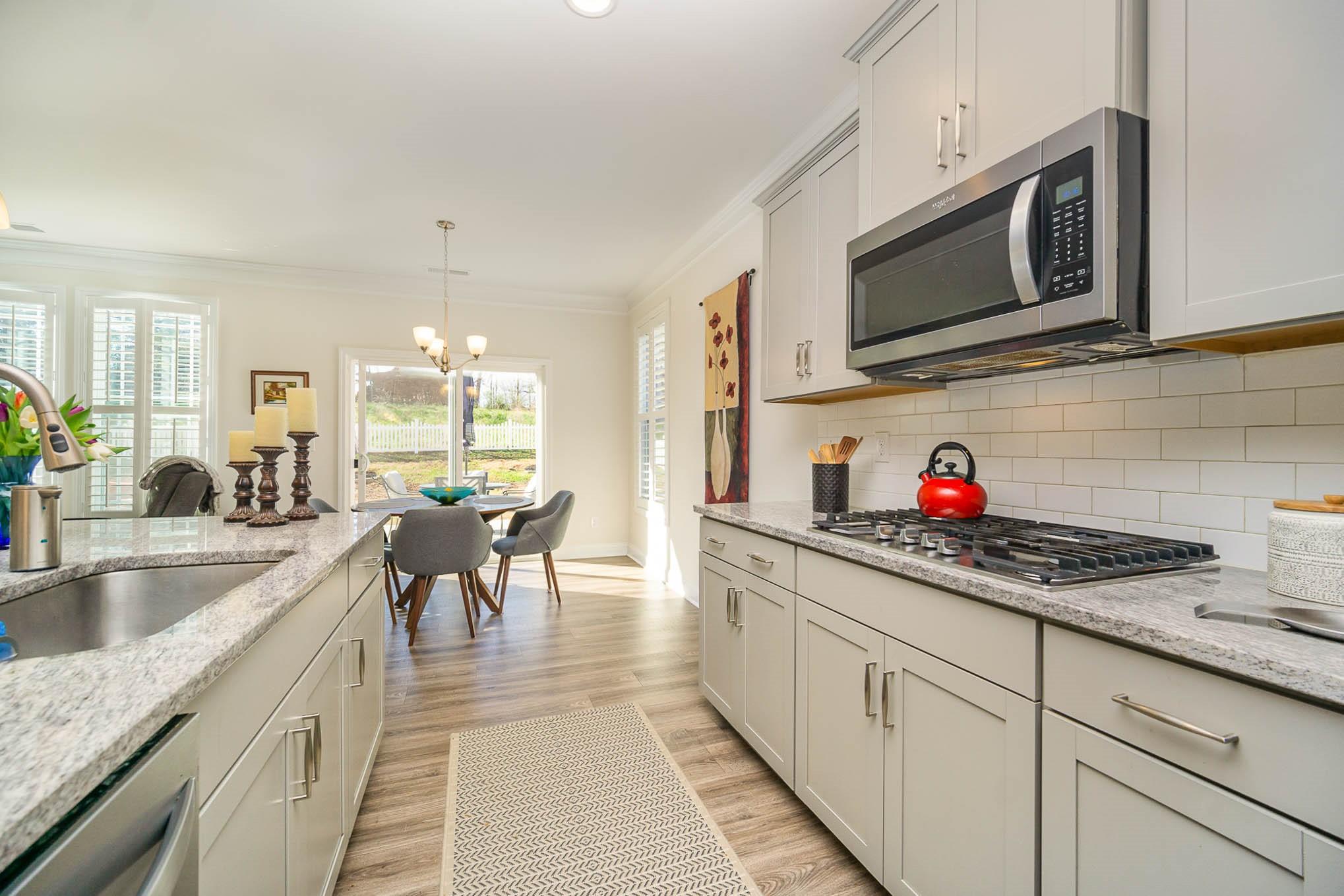 6029 Redwood Pine Road Concord, NC 28027 - Photo 13 of 48 a kitchen with stainless steel appliances granite countertop a sink stove and microwave