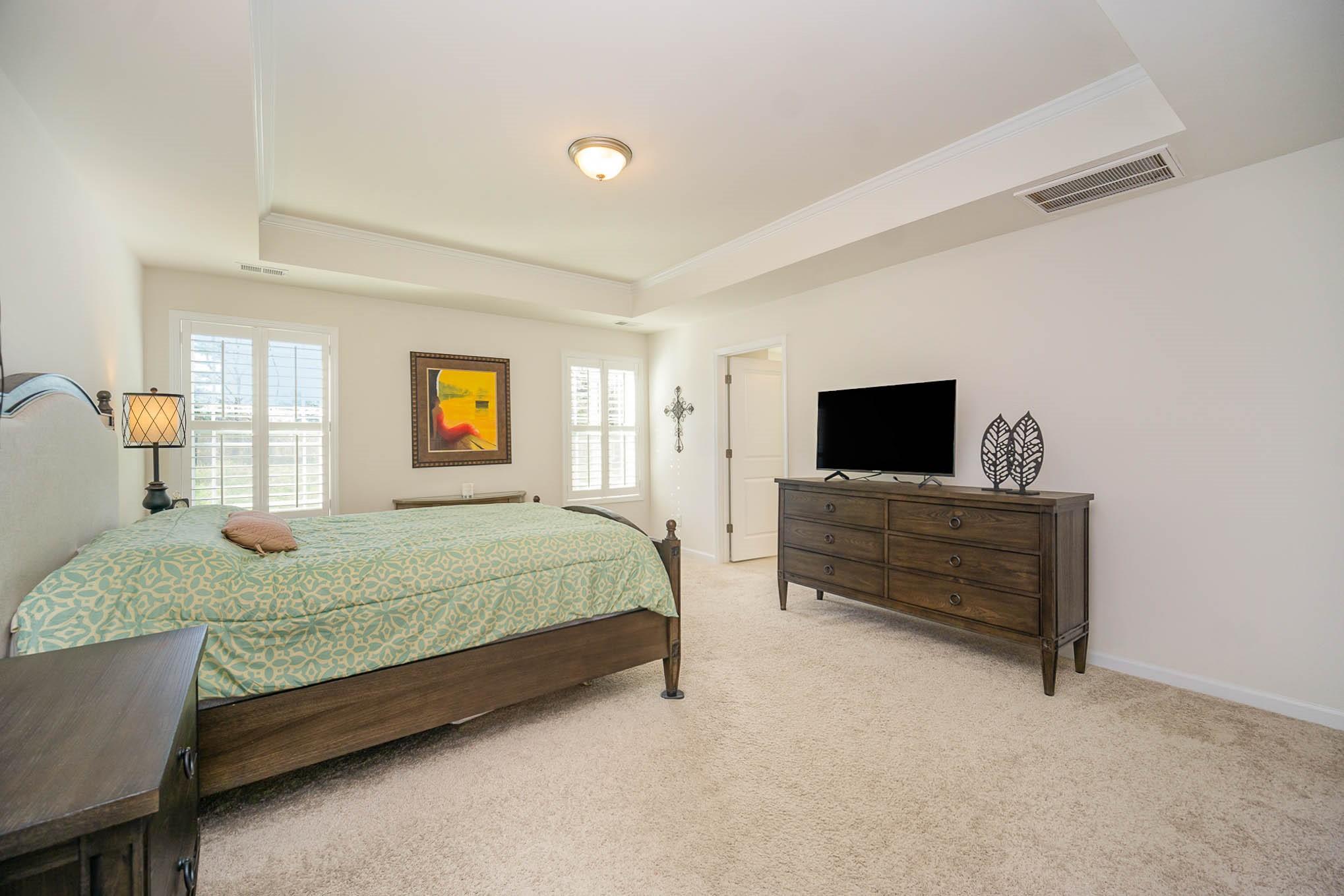 6029 Redwood Pine Road Concord, NC 28027 - Photo 19 of 48 a bedroom with a bed and flat screen tv