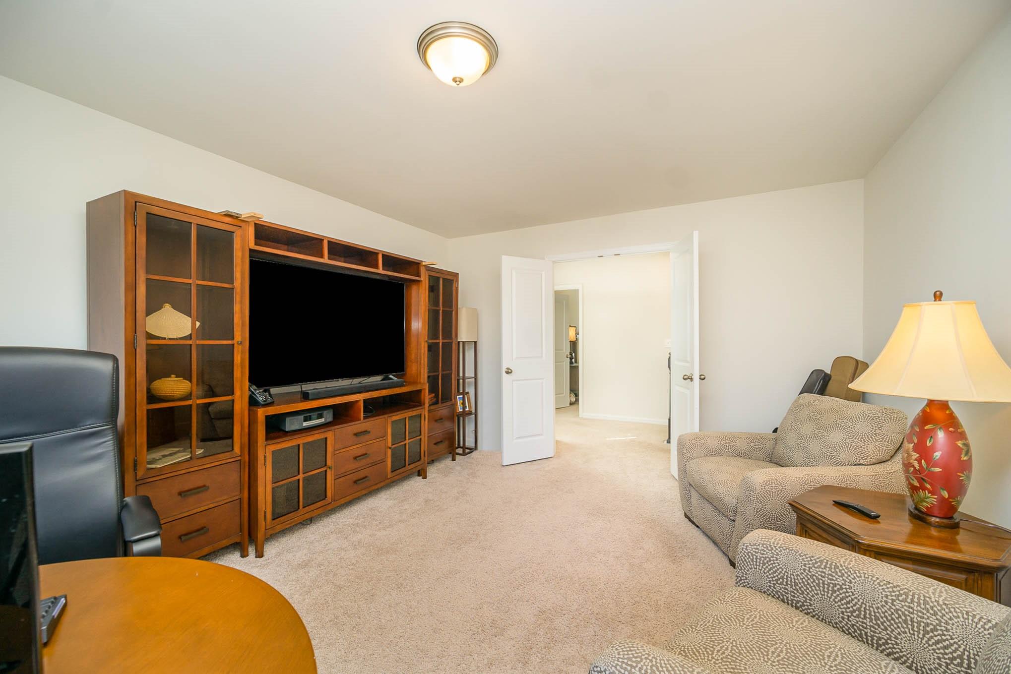 6029 Redwood Pine Road Concord, NC 28027 - Photo 26 of 48 a living room with furniture and a flat screen tv