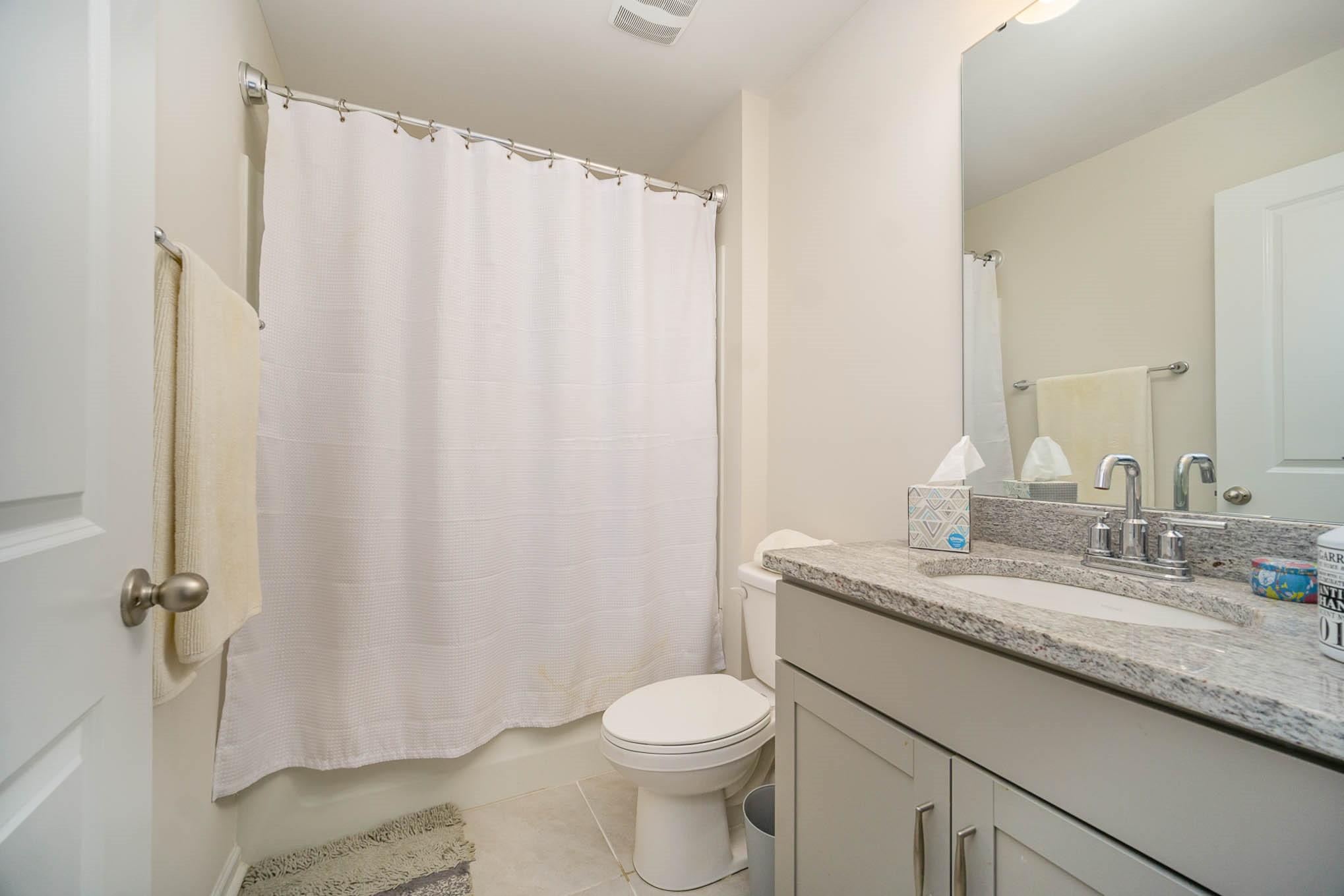 6029 Redwood Pine Road Concord, NC 28027 - Photo 33 of 48 a bathroom with a granite countertop toilet sink and mirror
