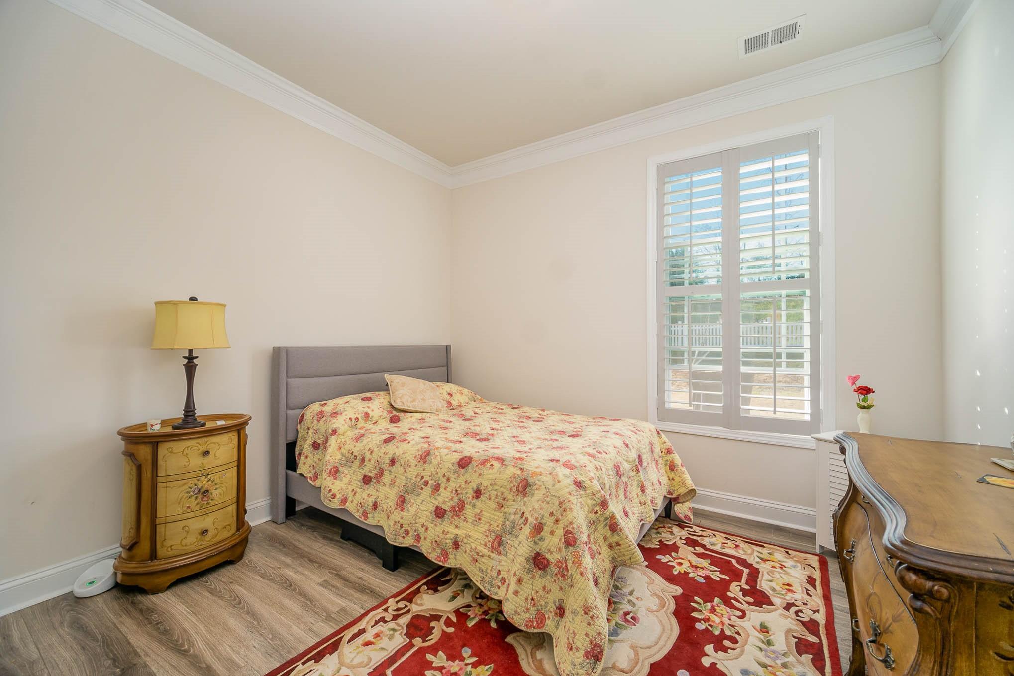 6029 Redwood Pine Road Concord, NC 28027 - Photo 34 of 48 a bed sitting in a bedroom next to a window