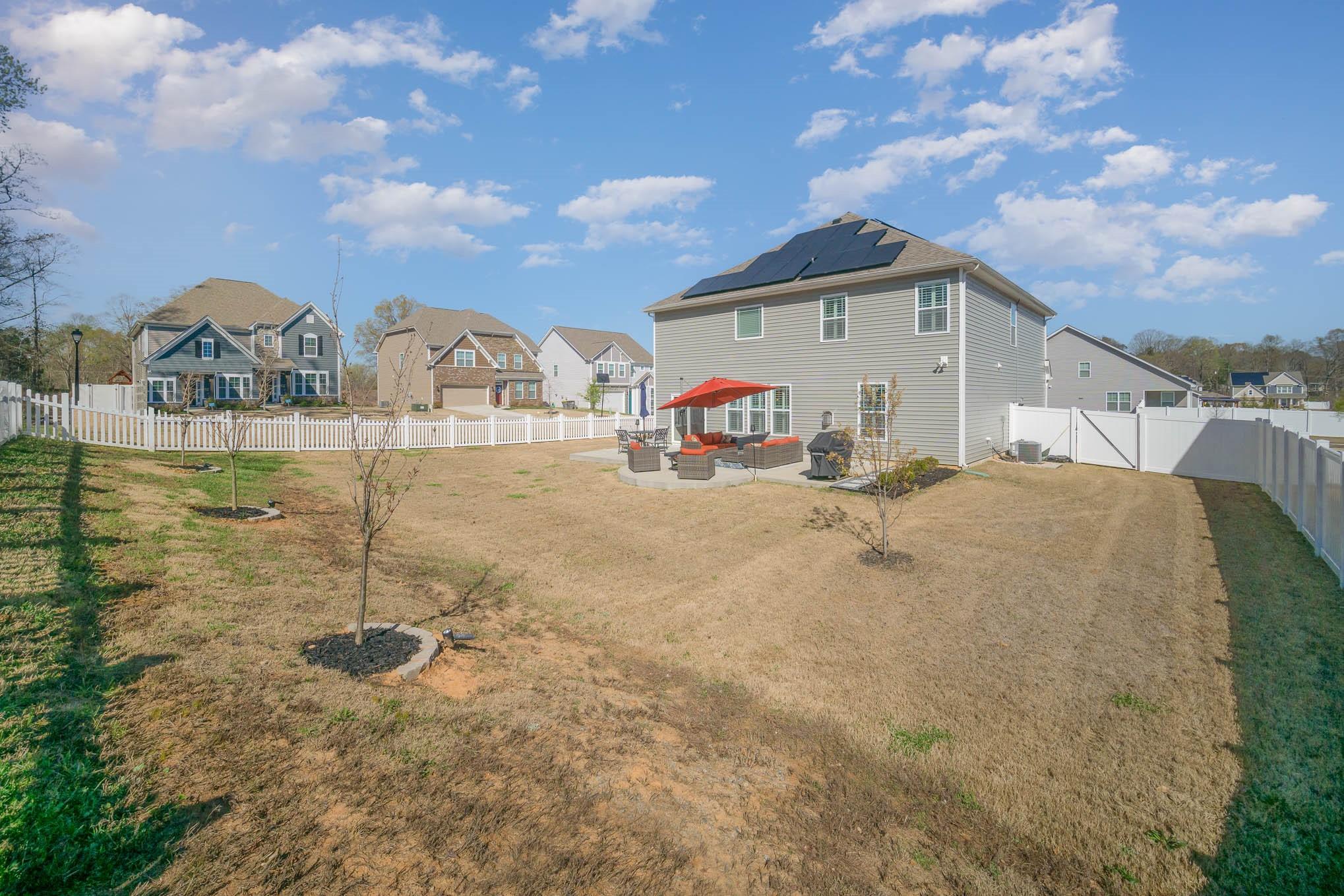 6029 Redwood Pine Road Concord, NC 28027 - Photo 38 of 48 a backyard of a house with table and chairs