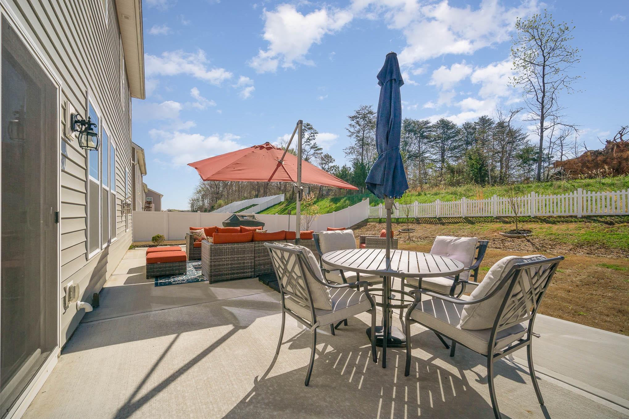 6029 Redwood Pine Road Concord, NC 28027 - Photo 43 of 48 a view of a patio with a table chairs and a fire pit