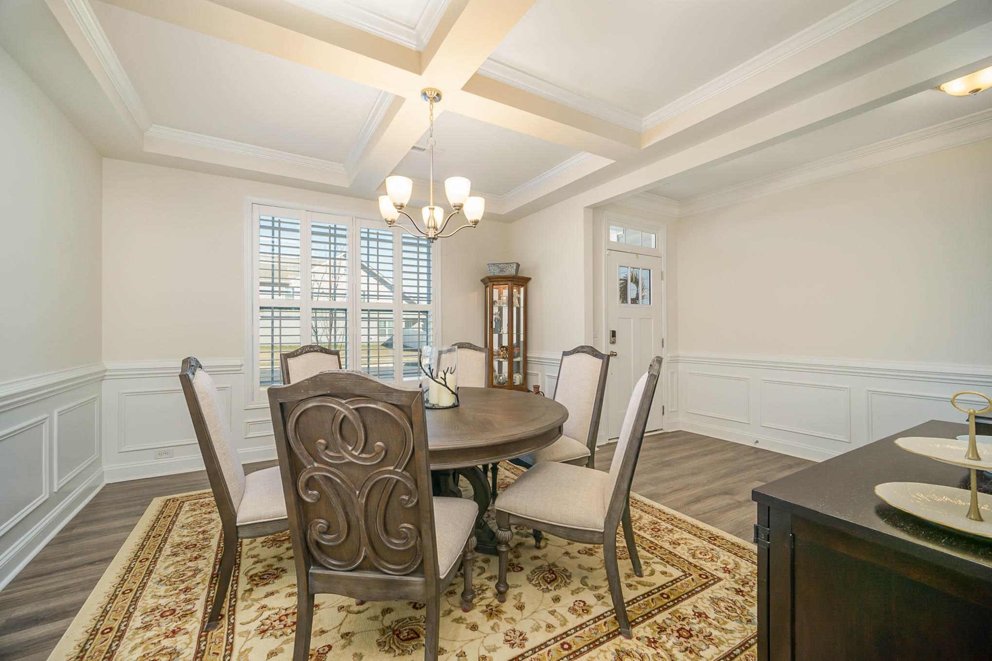 6029 Redwood Pine Road Concord, NC 28027 - Photo 6 of 48 a view of a dining room with furniture a chandelier and wooden floor