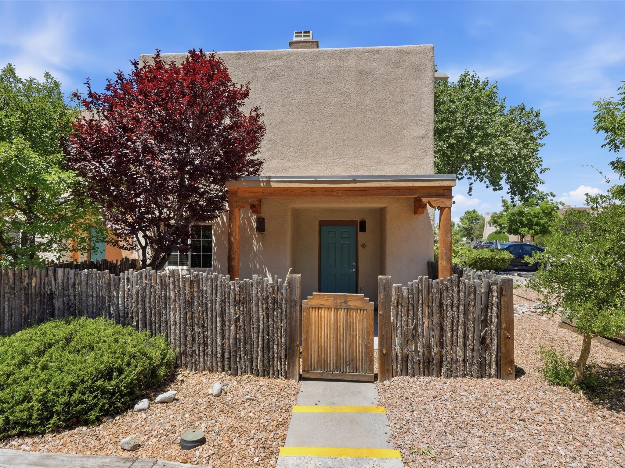 2210 Miguel Chavez Road, Unit 411 Santa Fe, NM 87505 - Photo 3 of 59 Facade of the unit with coyote fence for privacy
