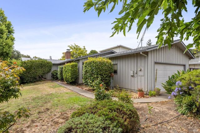 a backyard of a house with plants and trees