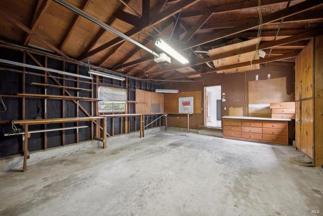 a view of an empty room with wooden walls