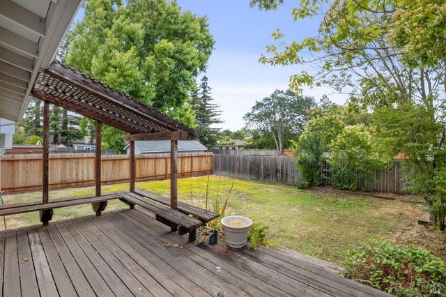 a view of a roof deck with wooden floor and fence