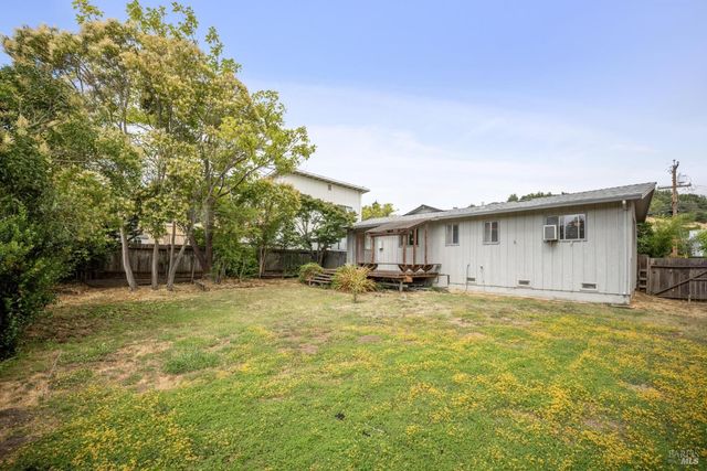a view of a house with pool and sitting area