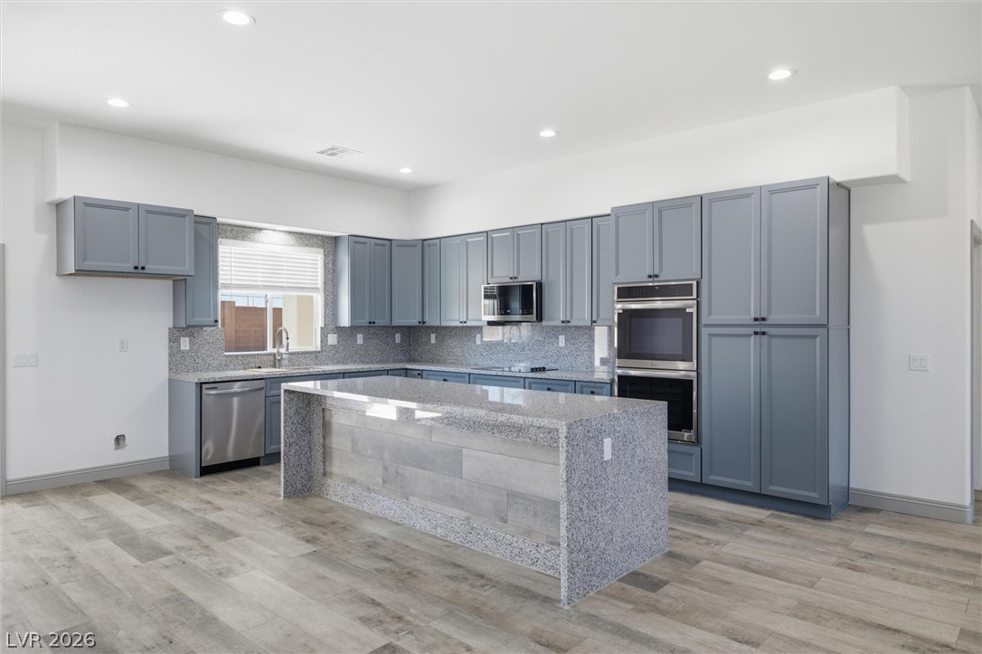 1061 Factory Road Pahrump, NV 89048 - Photo 12 of 41 Culinary aspirations come alive in this kitchen, featuring stainless steel appliances and a spacious island.