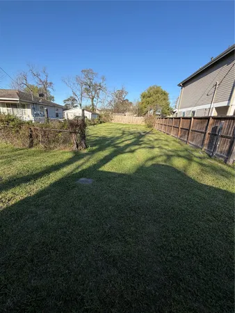 a view of a big yard with table and chairs