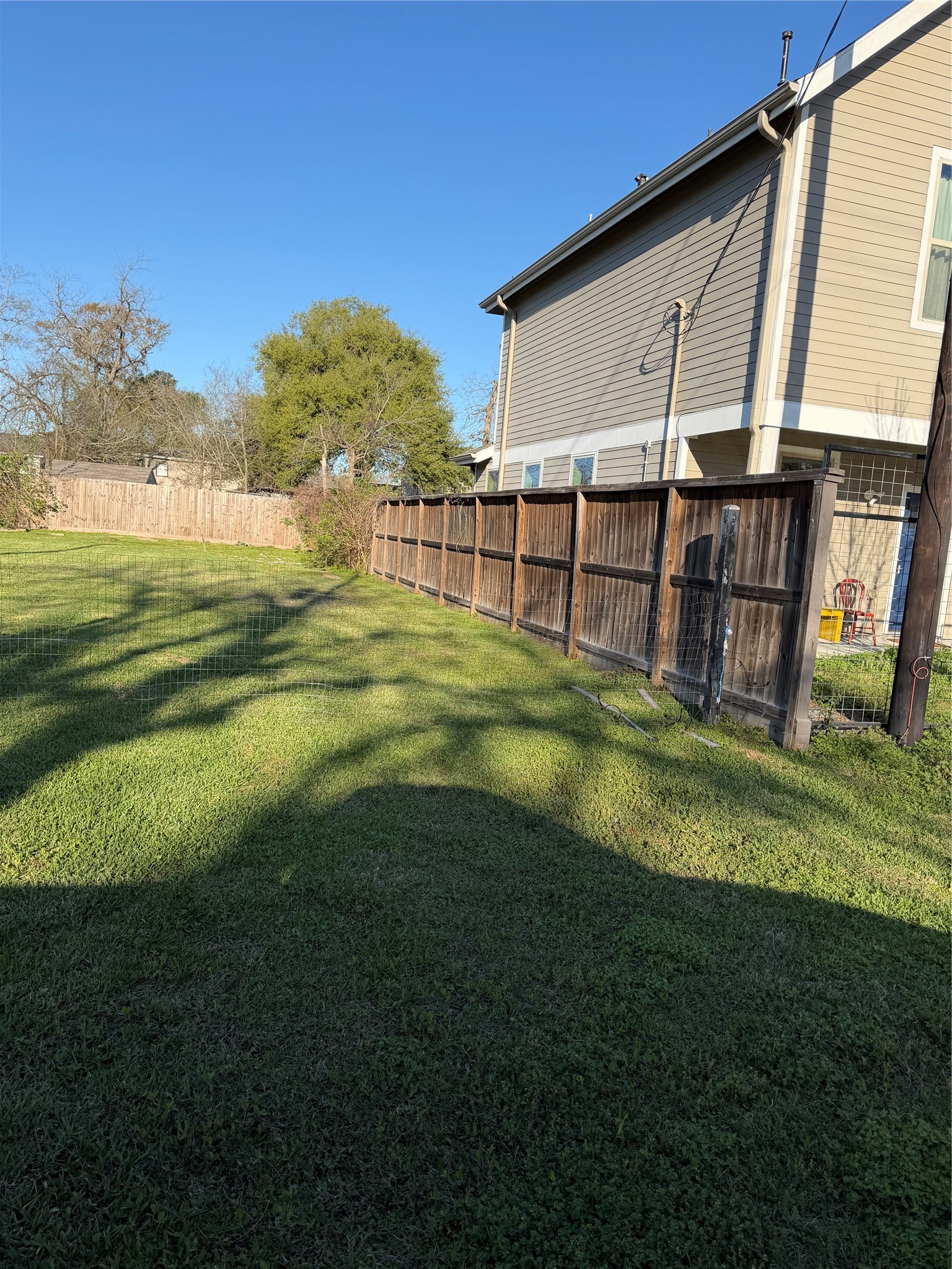 7009 Roswell Street Houston, TX 77022 - Photo 4 of 6 a view of a backyard with plants and a patio