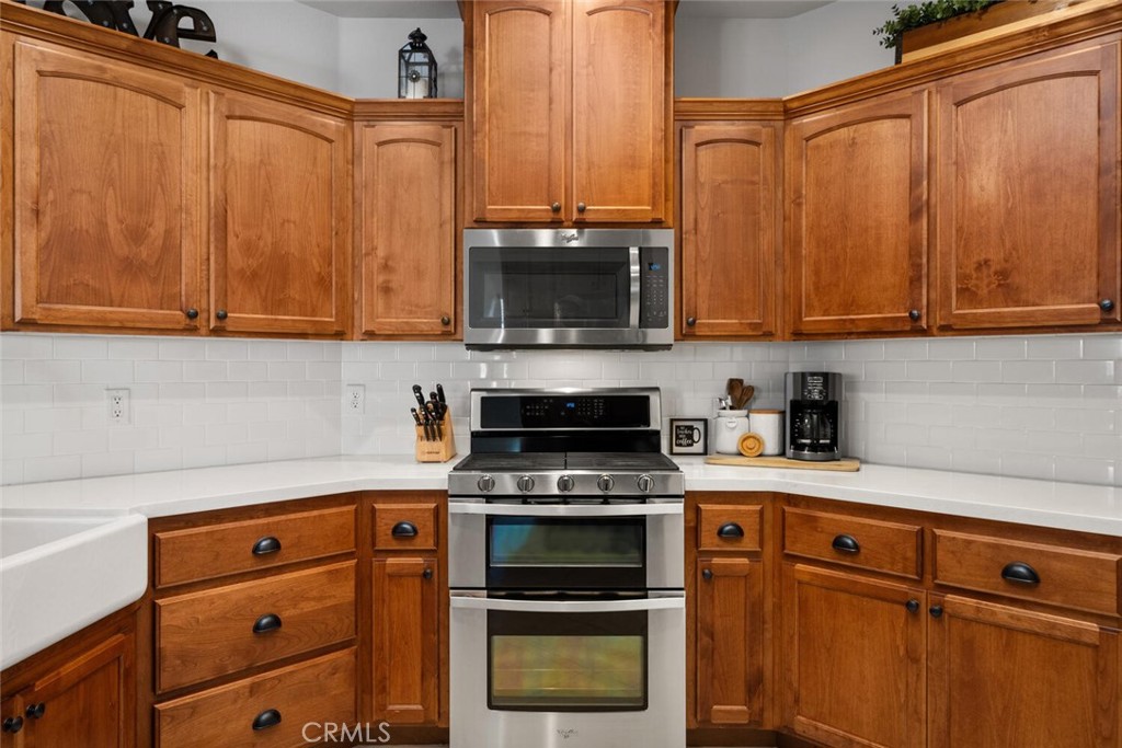 2816 Levi Lane Chico, CA 95973 - Photo 11 of 35 a kitchen with granite countertop a stove and a microwave