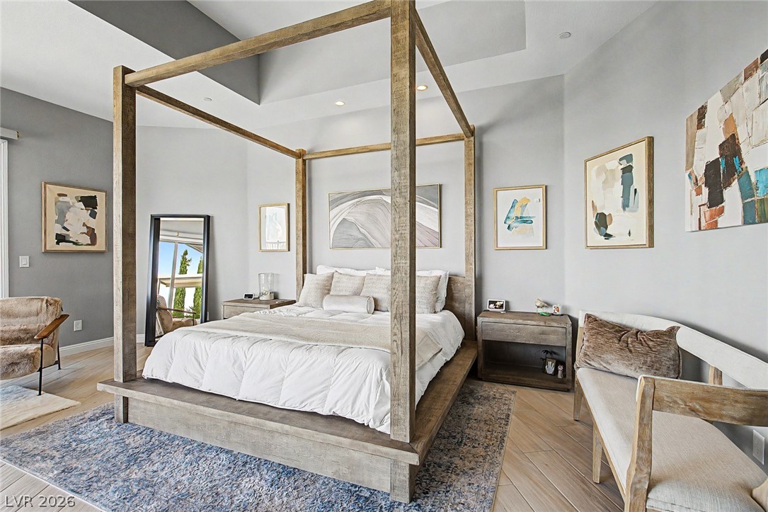 6014 Willow Ridge Court Las Vegas, NV 89135 - Photo 39 of 99 This spacious bedroom features a distinctive four-poster bed and elegant hardwood flooring.