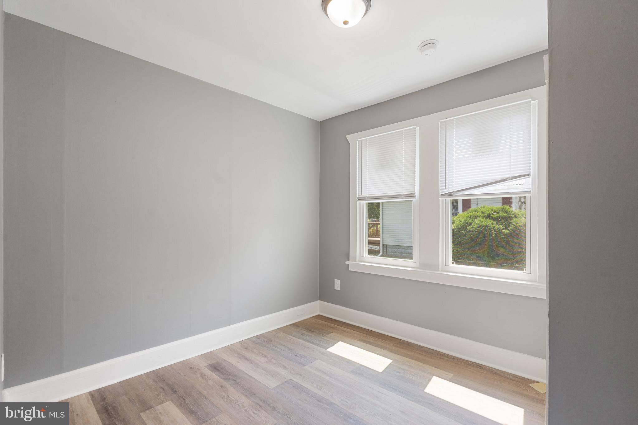 109 Georgia Road Pennsville, NJ 08070 - Photo 12 of 40 an empty room with wooden floor and windows