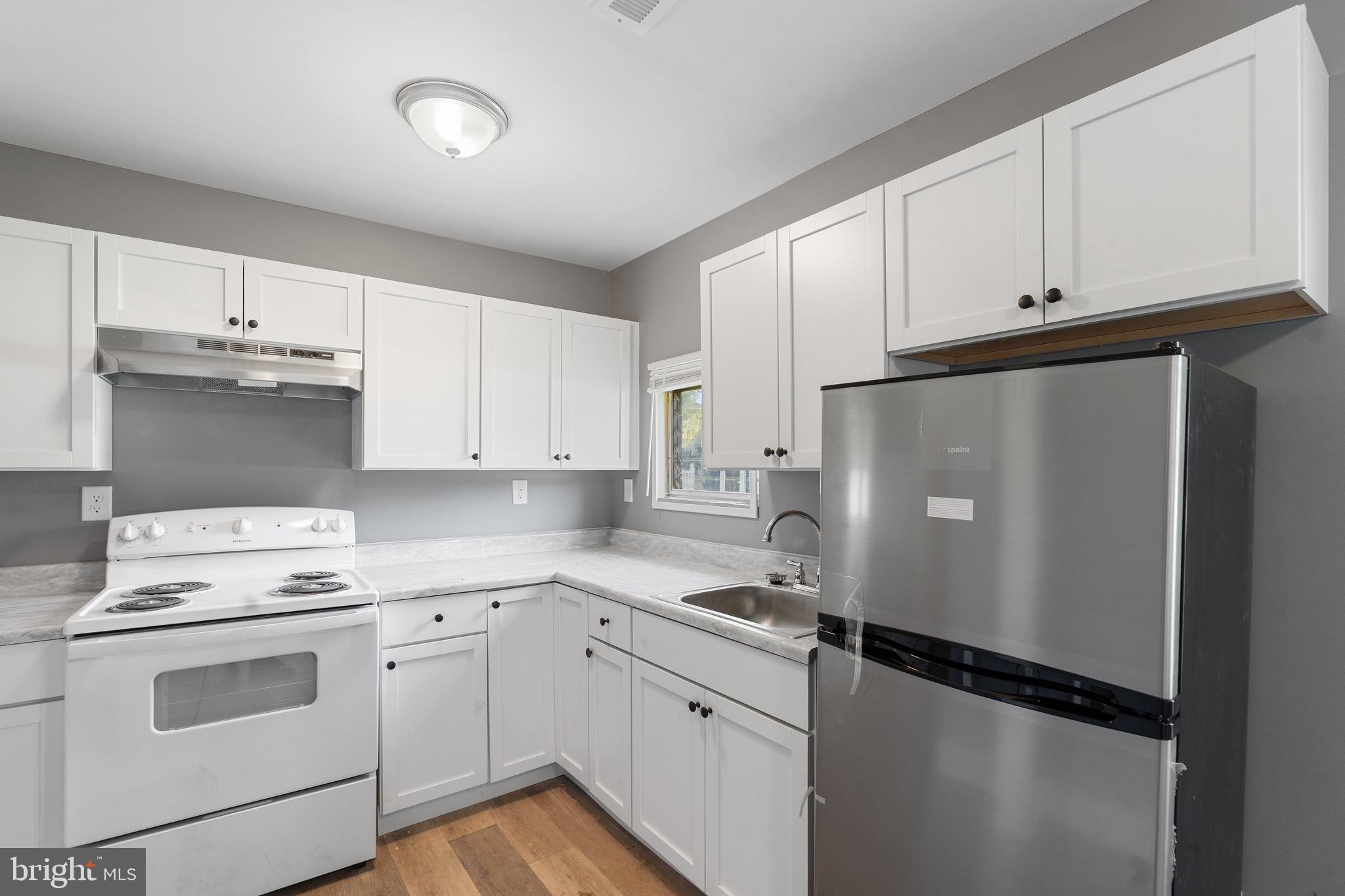 109 Georgia Road Pennsville, NJ 08070 - Photo 15 of 40 a kitchen with a white cabinets and white appliances