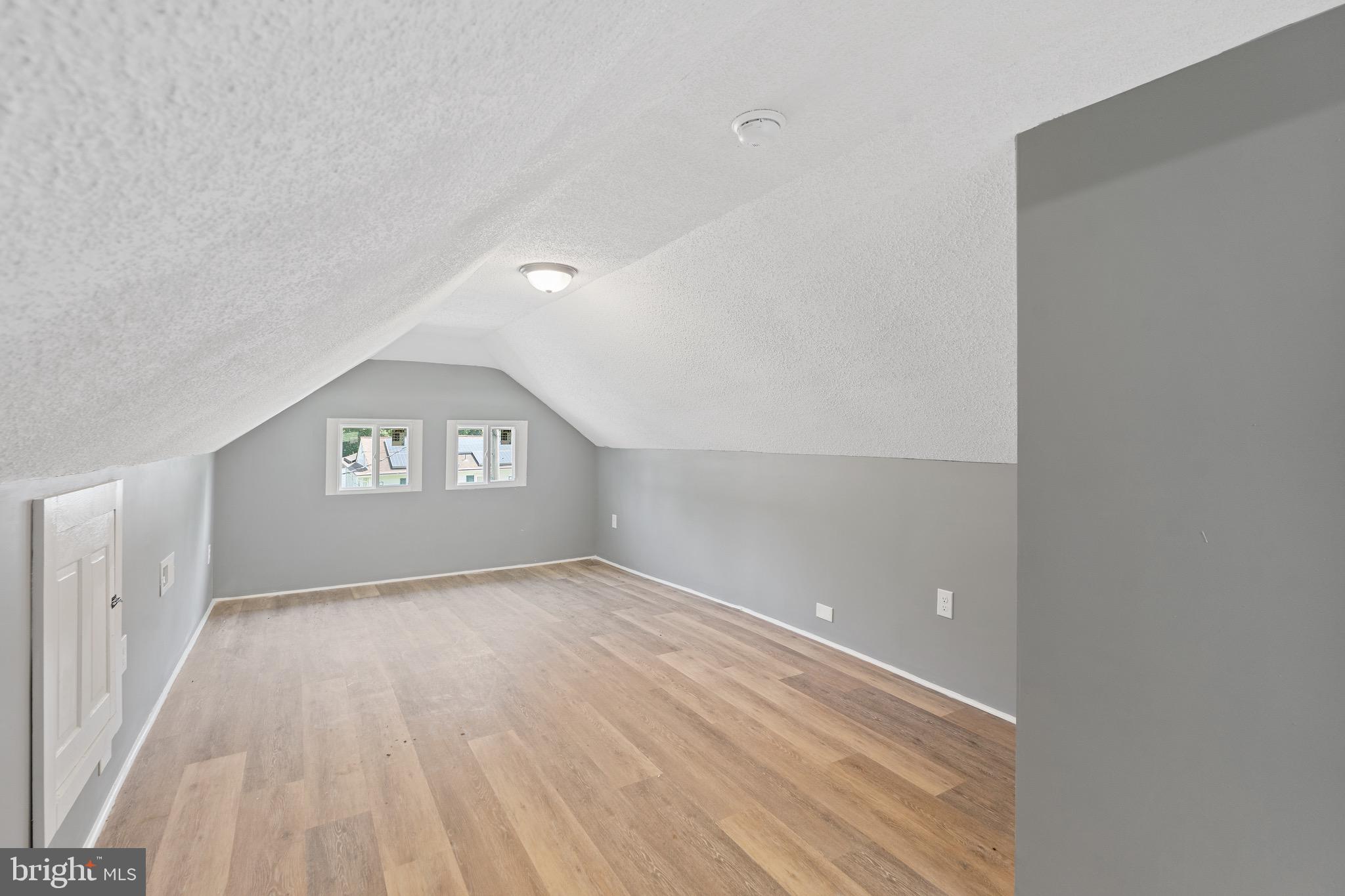 109 Georgia Road Pennsville, NJ 08070 - Photo 29 of 40 a view of a big room with wooden floor and windows