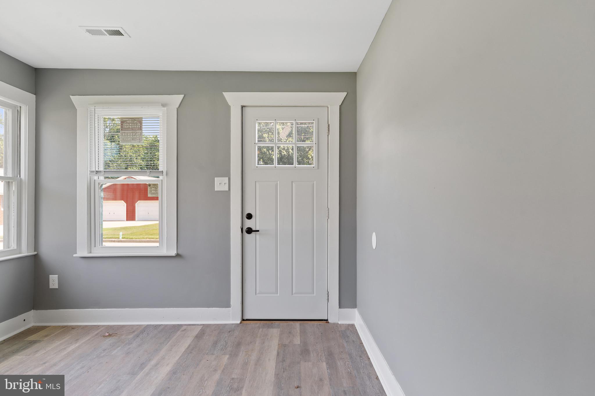 109 Georgia Road Pennsville, NJ 08070 - Photo 4 of 40 an empty room with wooden floor and windows