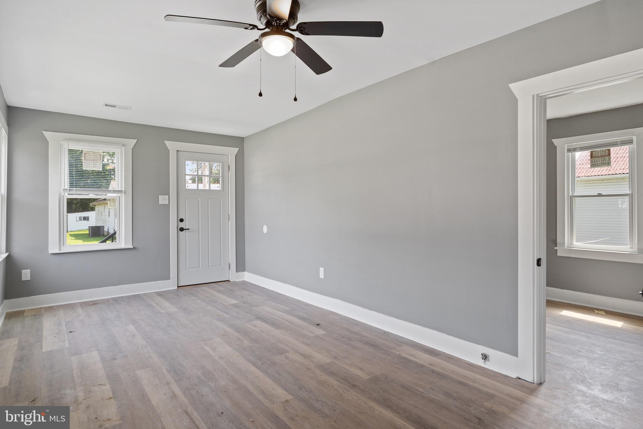 109 Georgia Road Pennsville, NJ 08070 - Photo 7 of 40 an empty room with windows and fan