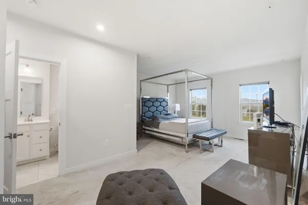 a living room with furniture a table and white walls