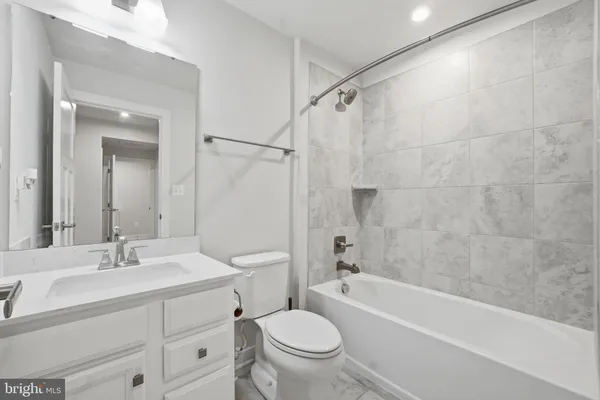 a bathroom with a sink toilet a mirror and shower