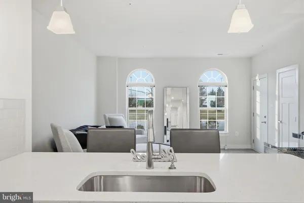 a living room with furniture and two large window