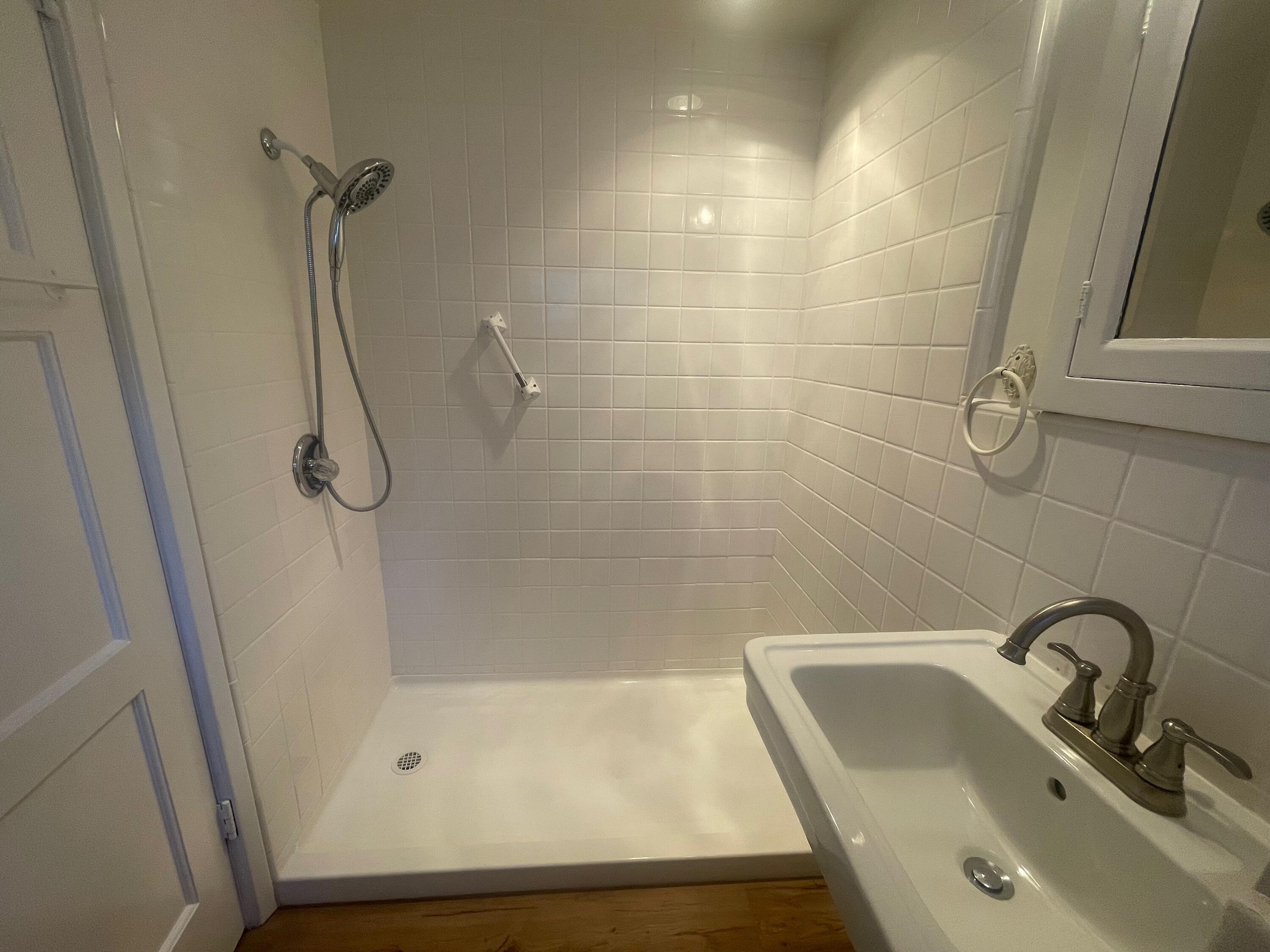 5161 6th Street Carpinteria, CA 93013 - Photo 13 of 27 a bathroom with a granite countertop sink a toilet and shower