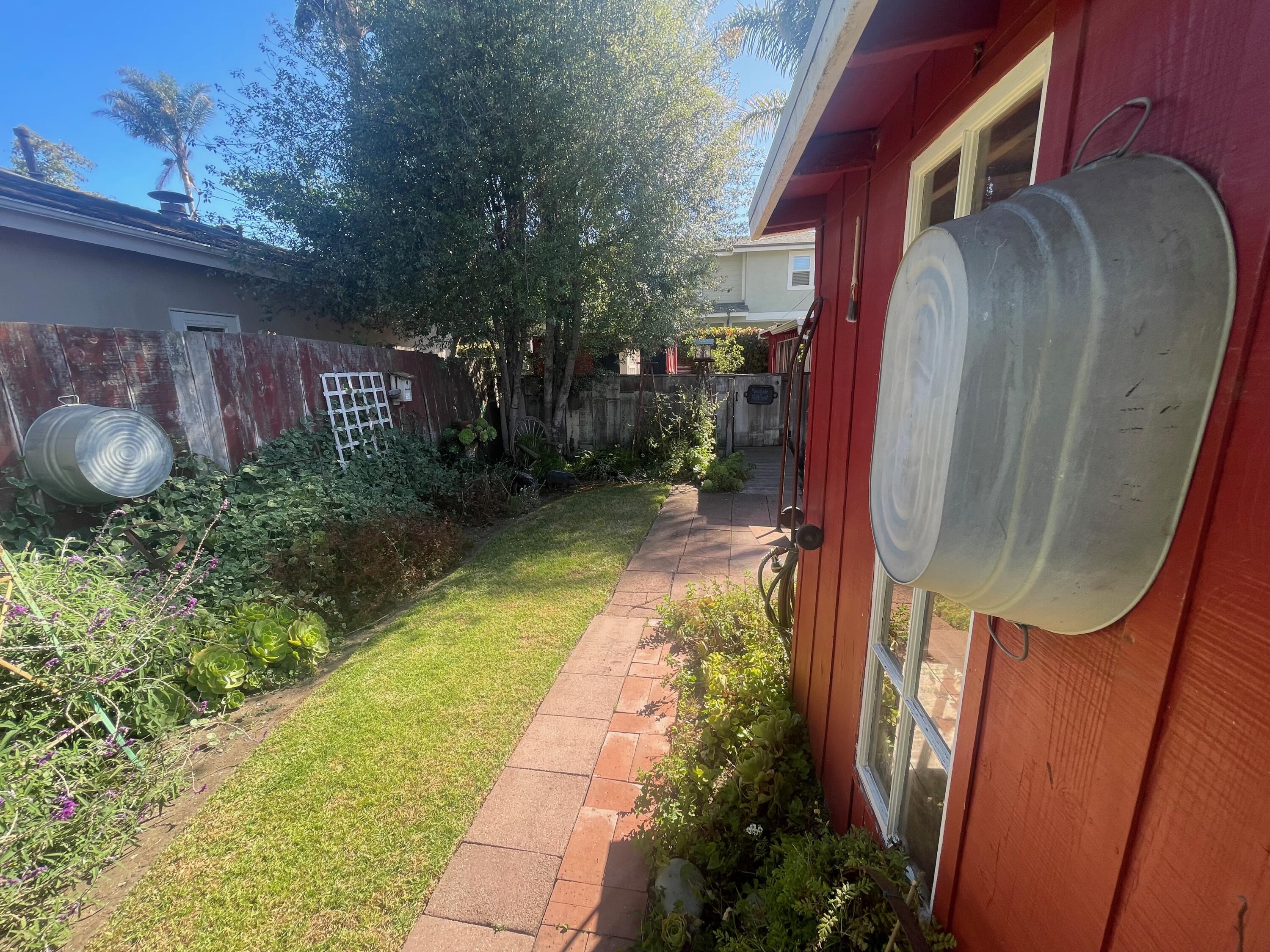 5161 6th Street Carpinteria, CA 93013 - Photo 26 of 27 a backyard of a house with lots of green space and plants