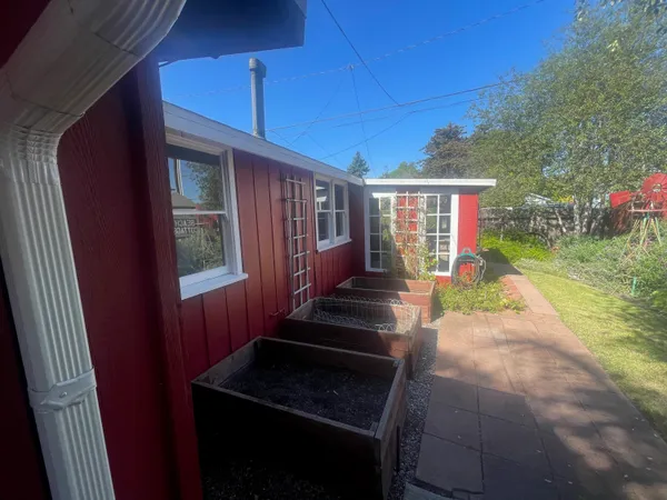 a view of a backyard with seating space