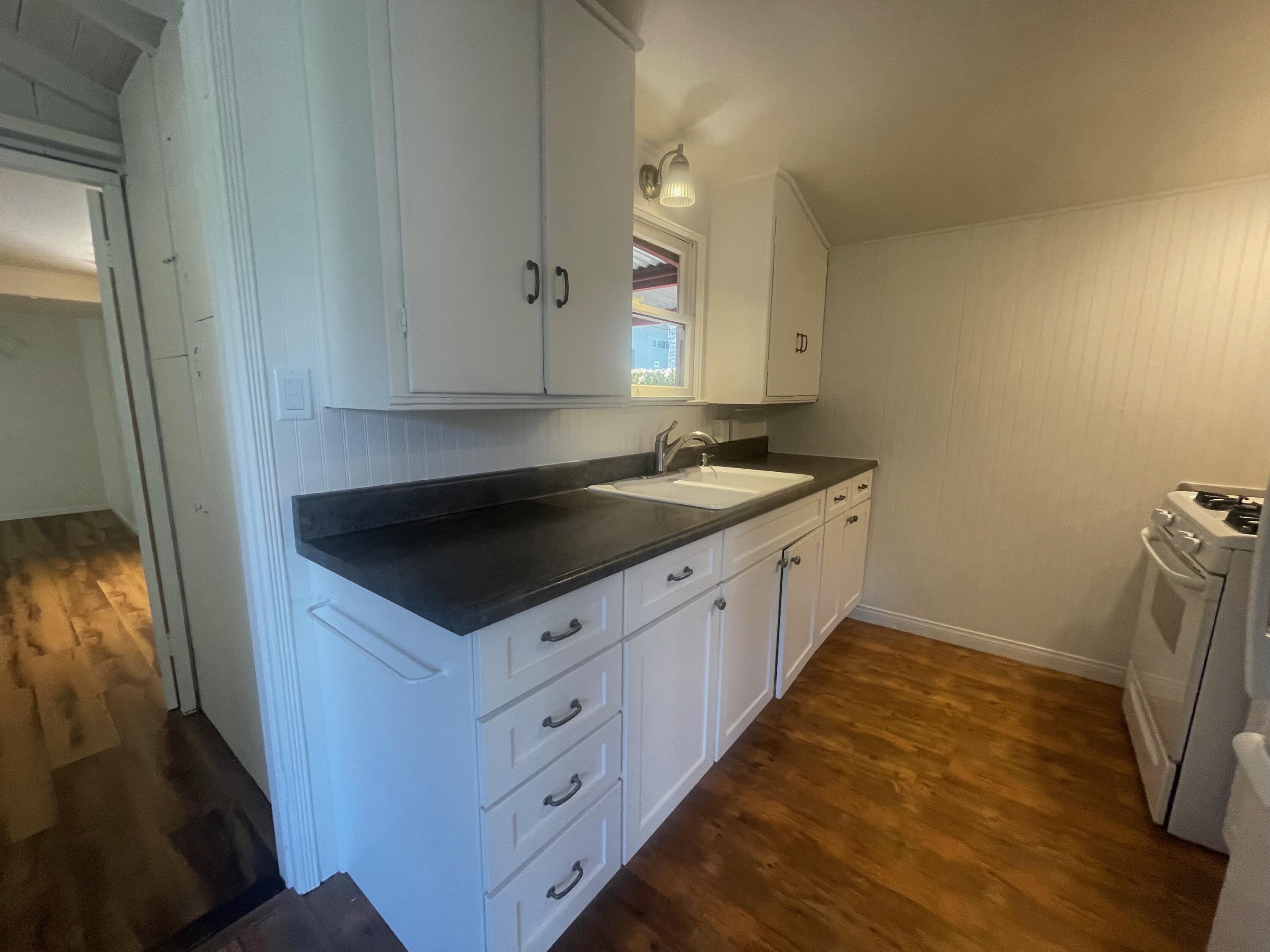 5161 6th Street Carpinteria, CA 93013 - Photo 4 of 27 a kitchen with a sink and a stove top oven