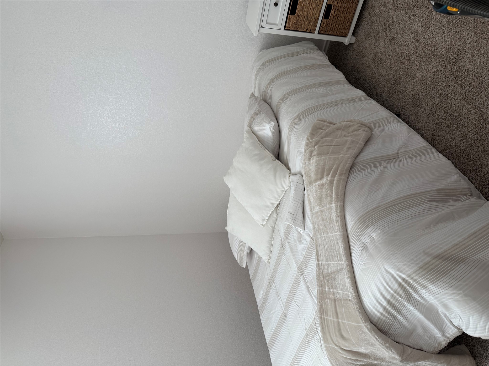 14907 Retha Pass Austin, TX 78725 - Photo 3 of 12 A well-maintained bedroom offers cozy carpeting, creating a comfortable and inviting atmosphere.