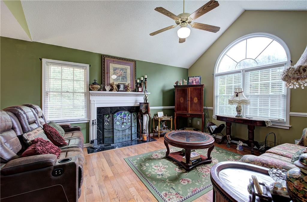 218 Gilreath Road Southeast Cartersville, GA 30121 - Photo 5 of 27 a living room with furniture a fireplace and window