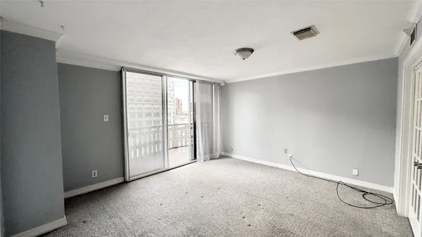 a view of an empty room with a window
