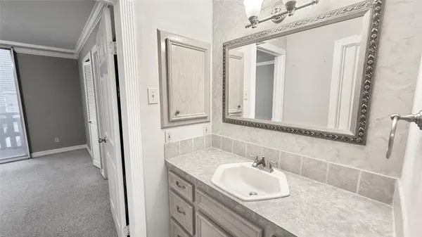 a view of a patio with dining table and chairs under an umbrella with a barbeque grill and couches