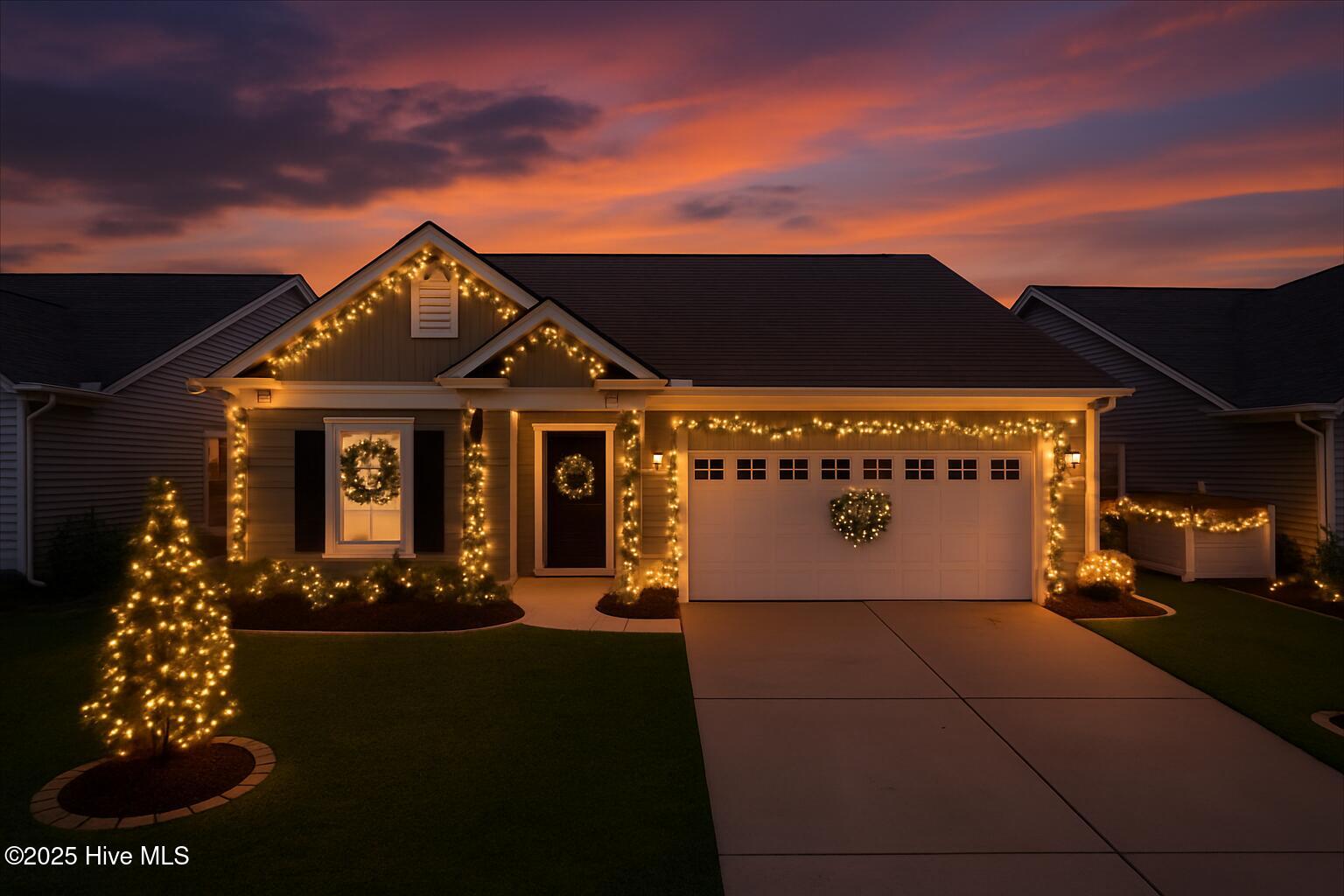 9355 Eagle Rdg Drive Calabash, NC 28467 - Photo 2 of 83 Virtually staged. A stunning twilight view of 9355 Eagle Ridge Drive illuminated with sophisticated Christmas lighting and garland, highlighting the home’s upscale coastal ambiance in the Eagle Run community