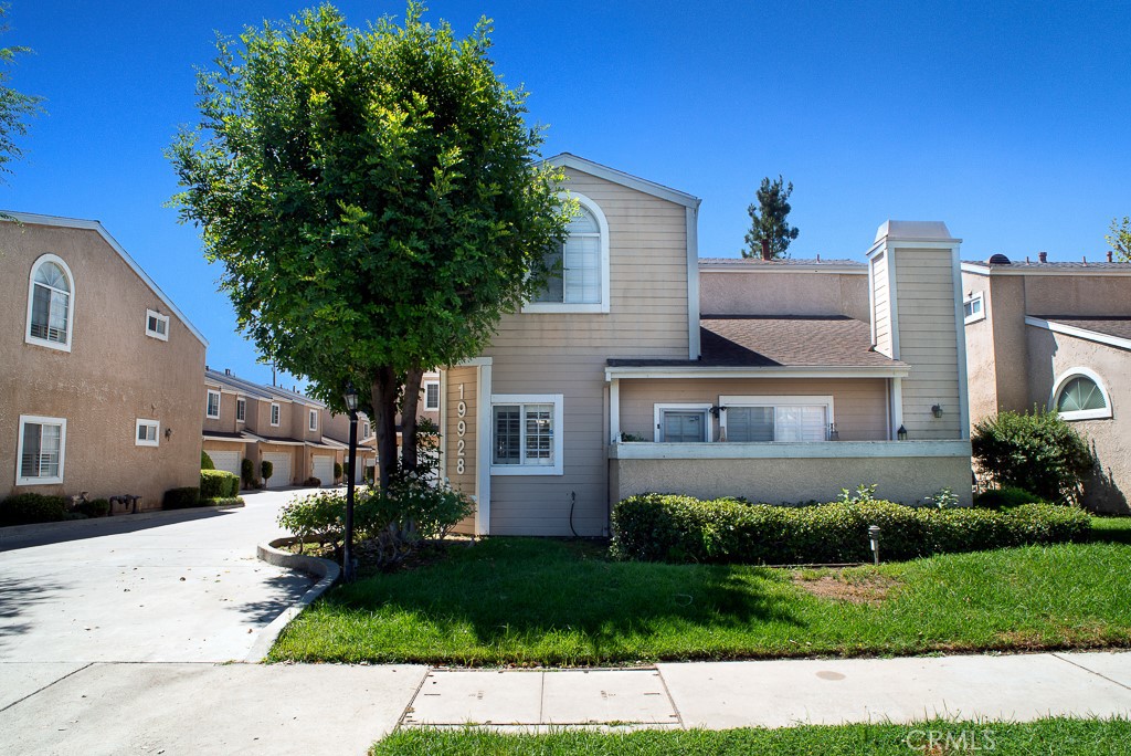 19928 Chase Street, Unit 2 Winnetka, CA 91306 - Photo 1 of 1 a front view of a house with a yard