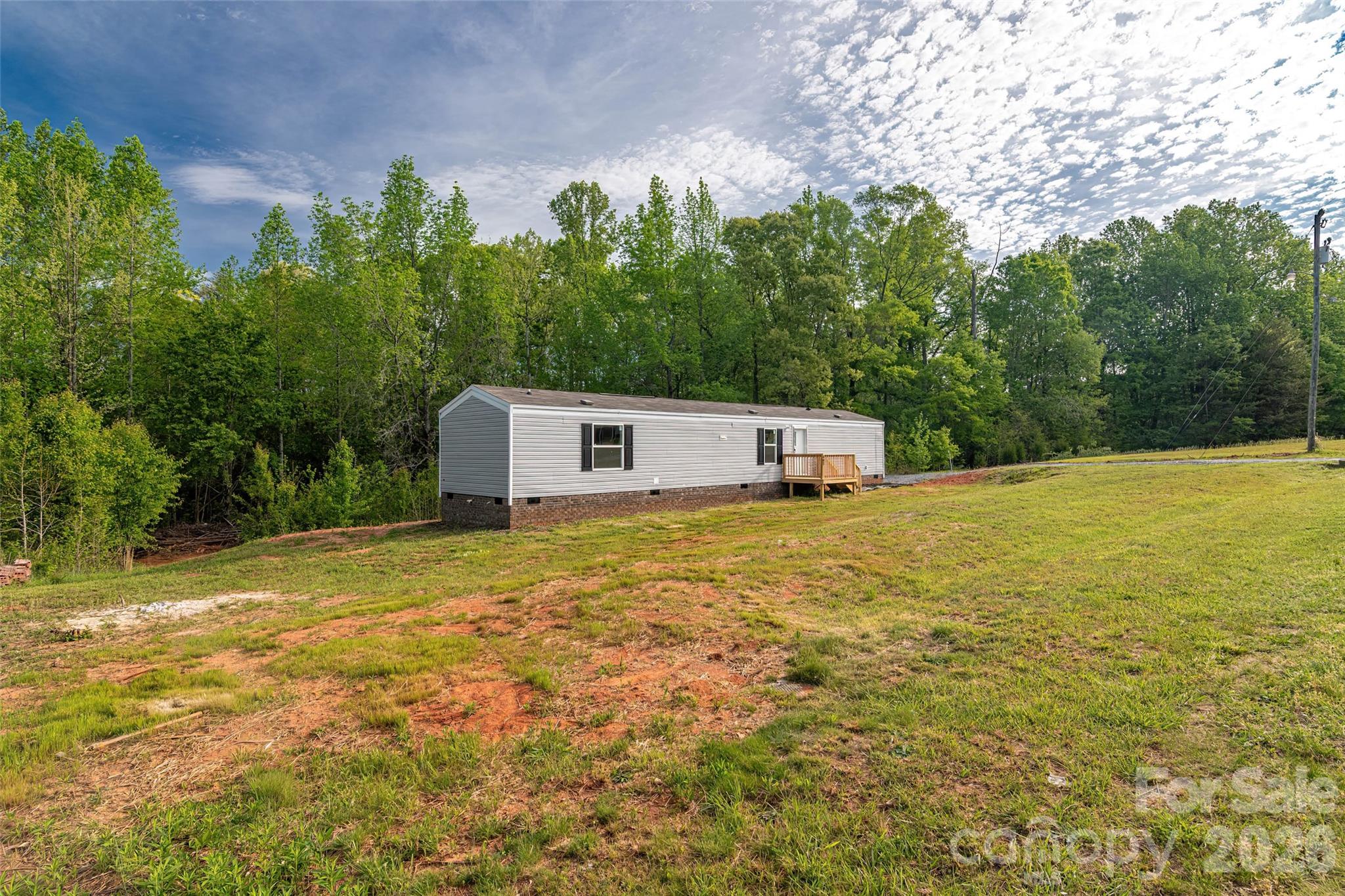 482 Jm Lovelace Road Ellenboro, NC 28040 - Photo 4 of 30 a front view of a house with a yard and a tree
