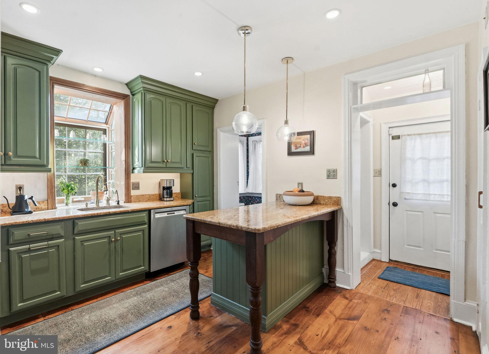 212 Benezet Street Philadelphia, PA 19118 - Photo 11 of 32 a view with kitchen island a sink stainless steel appliances and cabinets