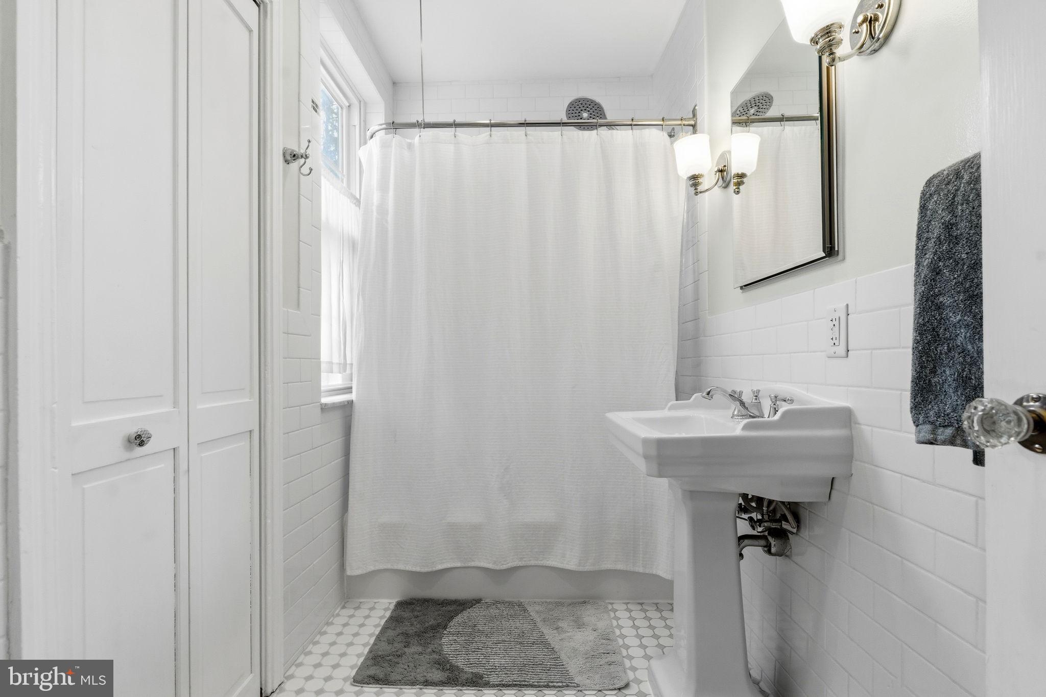 212 Benezet Street Philadelphia, PA 19118 - Photo 21 of 32 a bathroom with a sink a toilet and shower