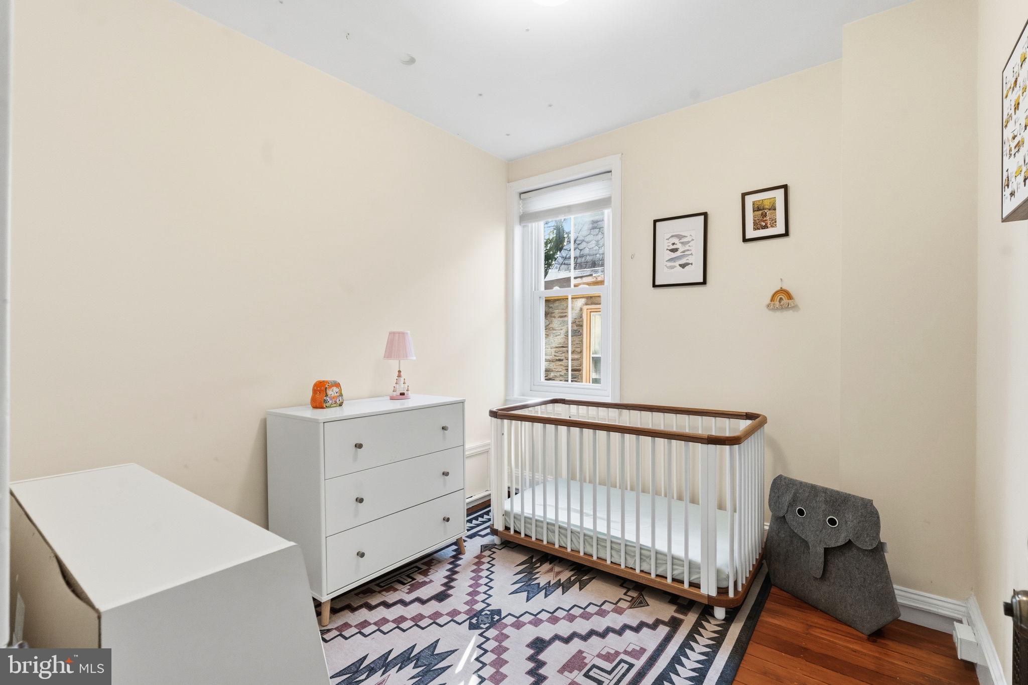 212 Benezet Street Philadelphia, PA 19118 - Photo 22 of 32 a bedroom with a baby bed baby crib and a dresser