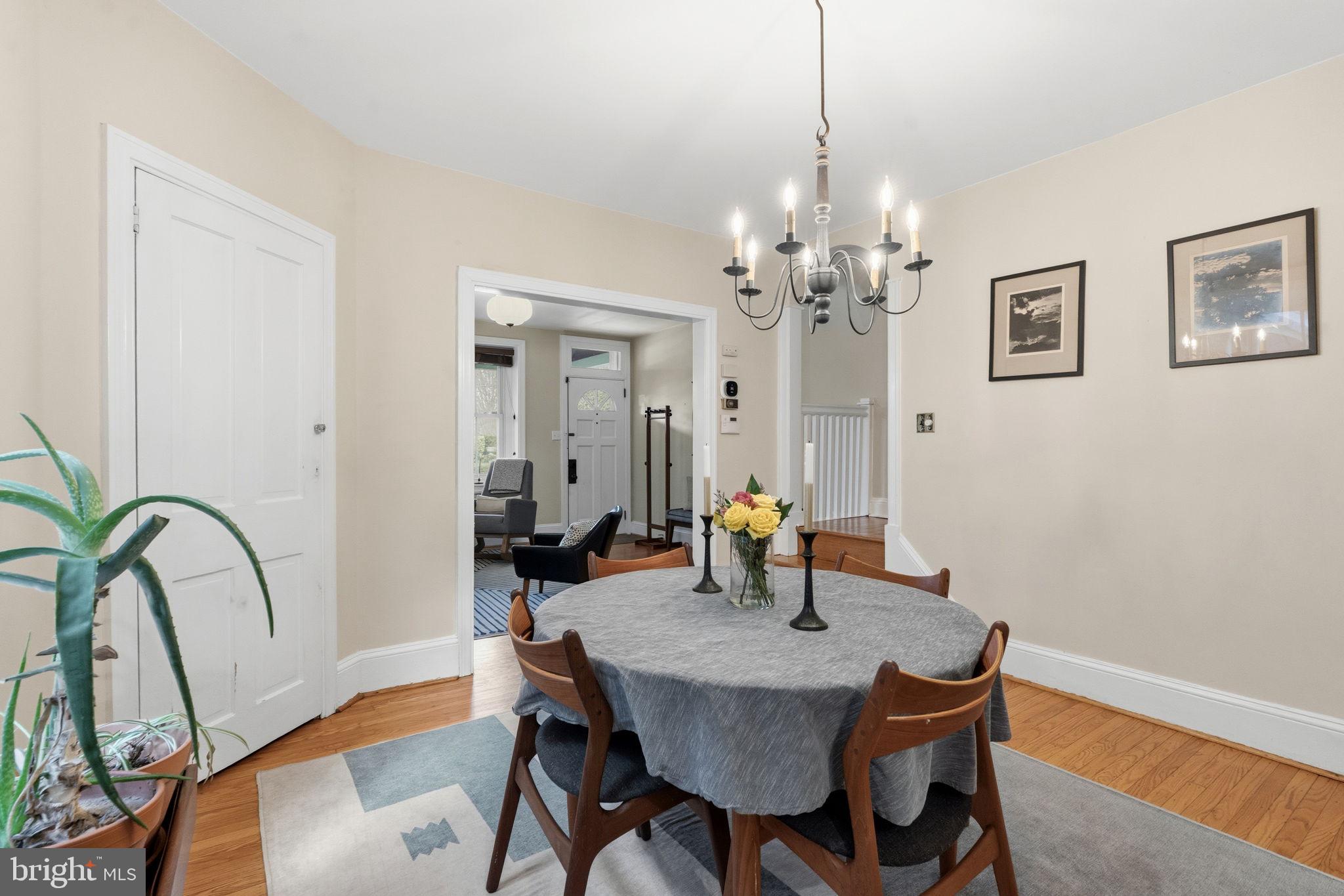 212 Benezet Street Philadelphia, PA 19118 - Photo 6 of 32 a dining room with furniture a chandelier and wooden floor
