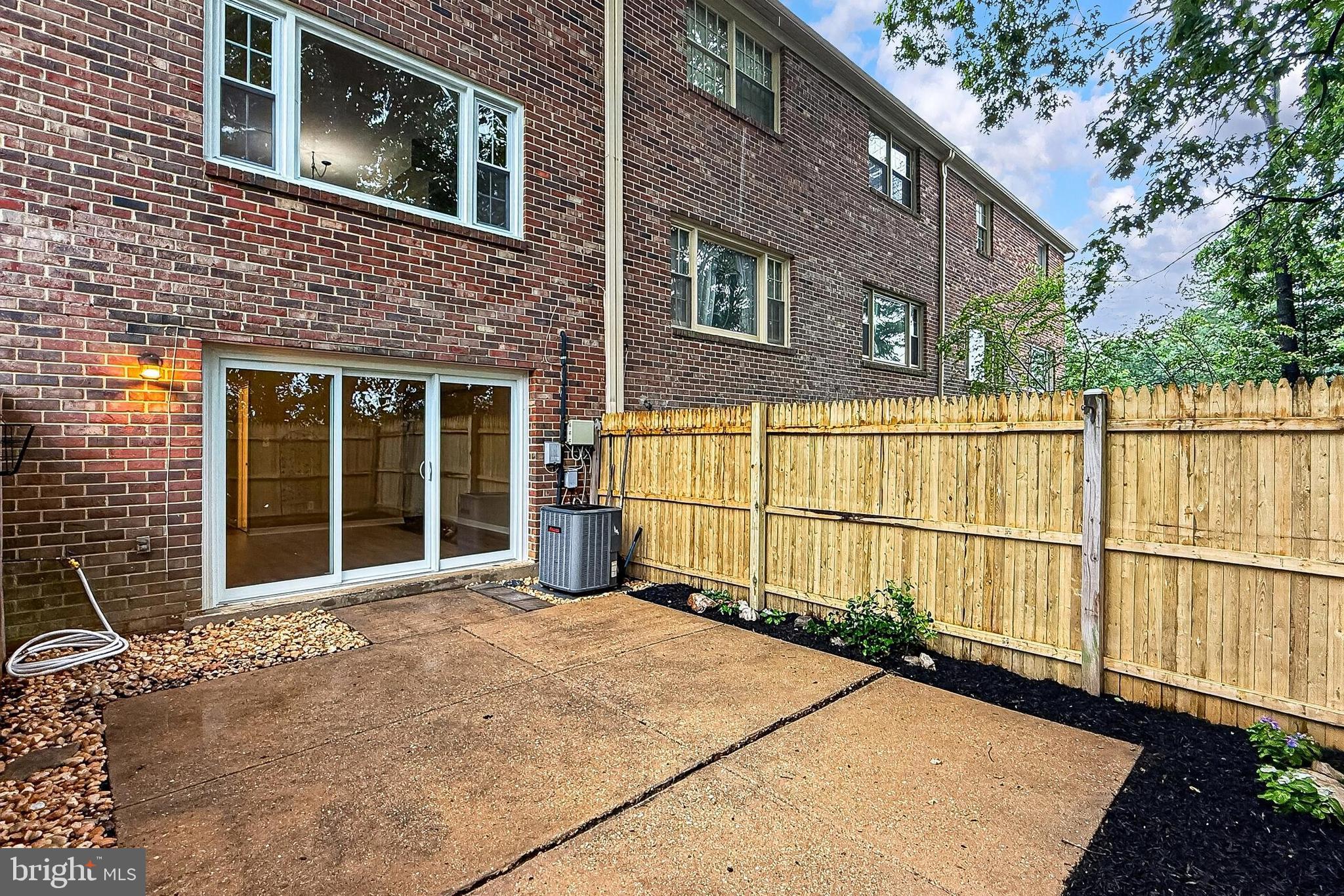 5833 Royal Ridge Drive, Unit 943 Springfield, VA 22152 - Photo 40 of 45 a view of a house with a wooden fence