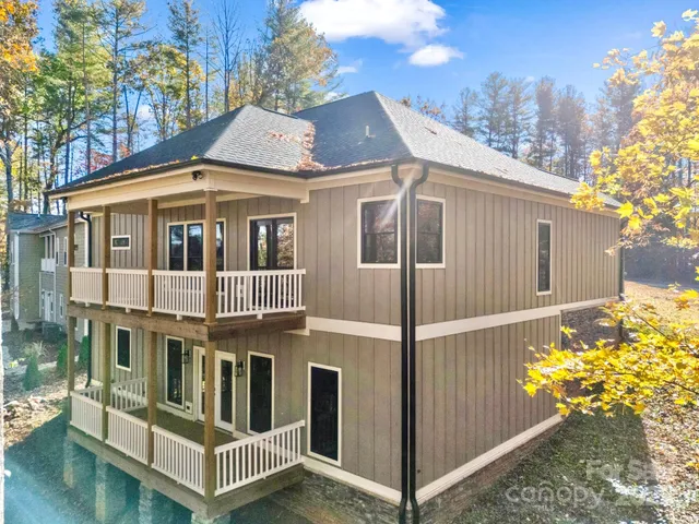 a living room with furniture a fireplace and wooden floor