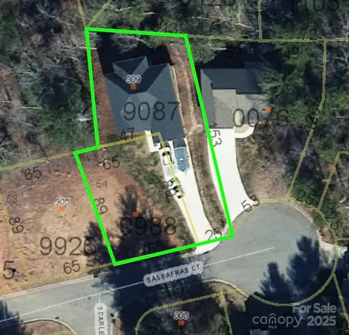 an empty room with wooden floor fireplace and windows