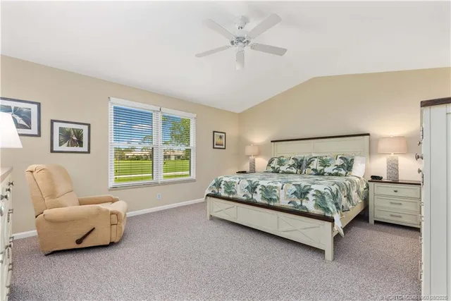 a spacious bedroom with a bed and a couch