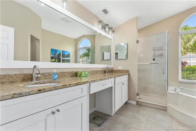 a bathroom with a granite countertop sink mirror and a